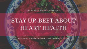 Blog banner. Background is a plate of beet hummus. Transparent pink textbox with white text that reads STY UP-BEET ABOUT HEART HEALTH: Including a heart healthy beet hummus recipe.
